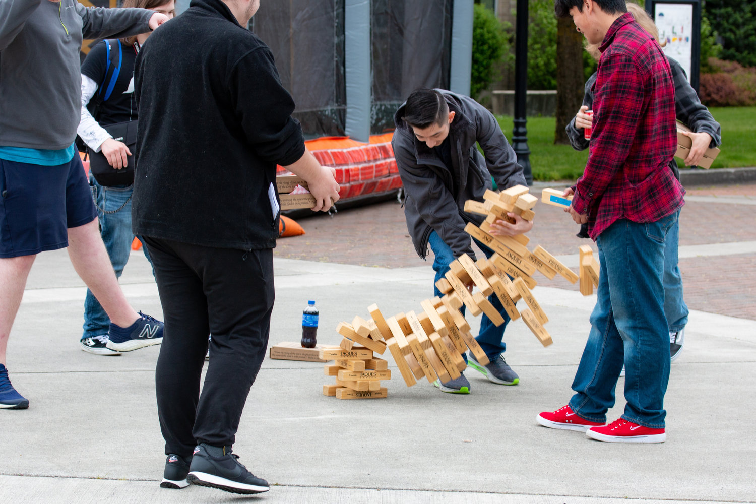 A student attempts to catch the collapsing jenga tower at the Centralia College SpringFest Tuesday afternoon.